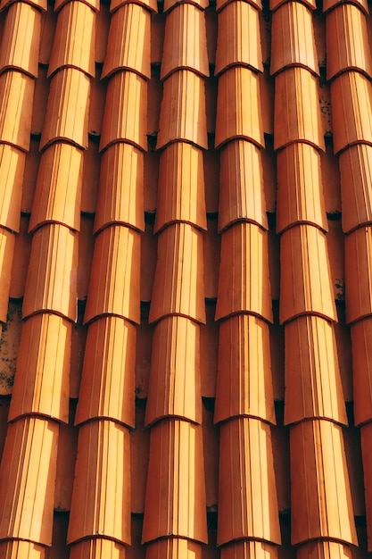 New clean brown tiles on the roof of the building