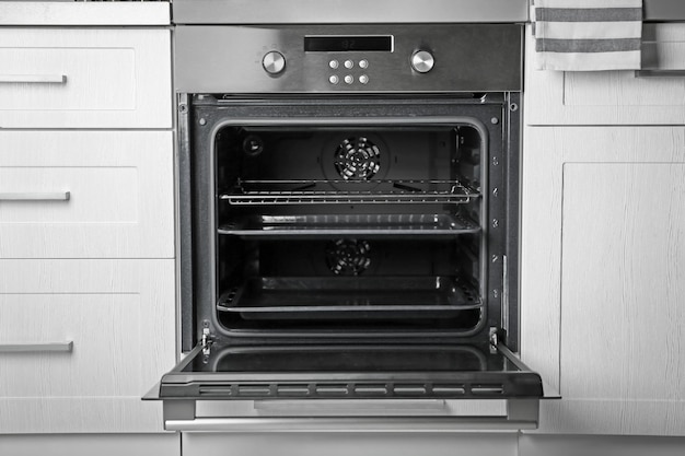 Photo new electric oven in kitchen