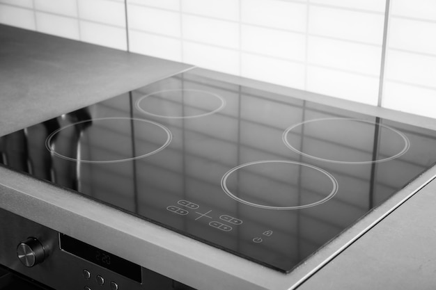 New electric stove with induction cooktop in kitchen closeup