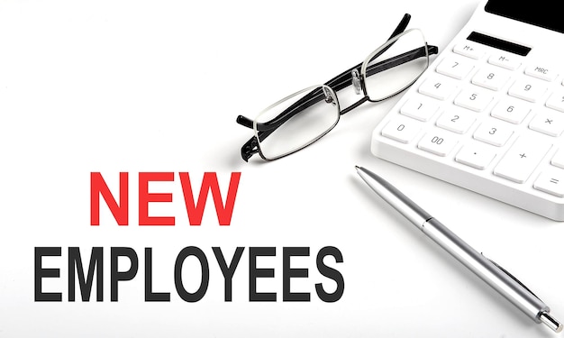 NEW EMPLOYEES Concept Calculatorpen and glasses on the white background