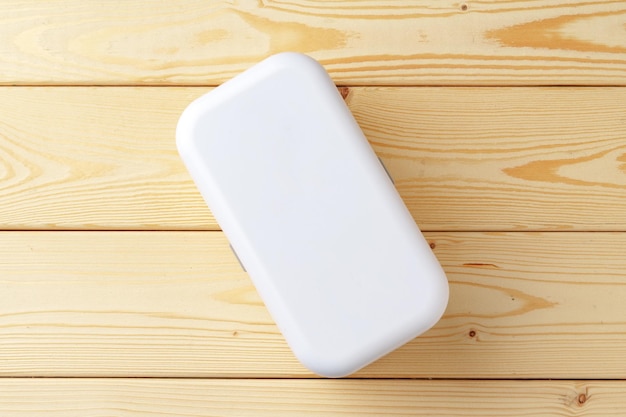 New empty plastic lunch box on a wooden background