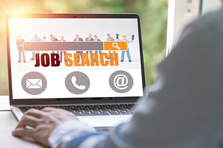 फोटो new graduate using laptop look for online new job search from head hunters website. recruitment concept.