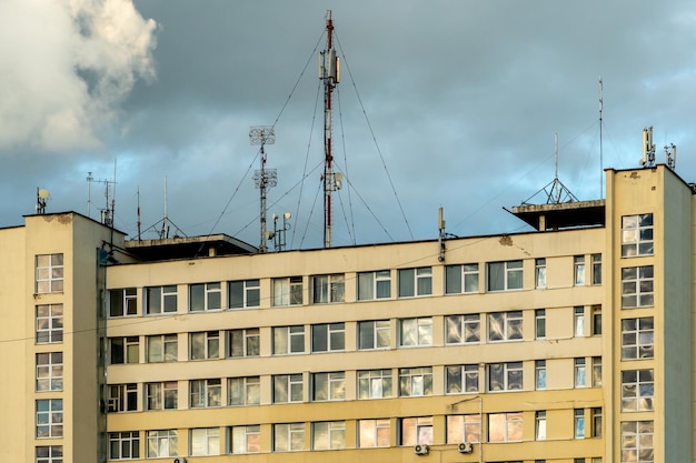 New gsm antennas on a high tower against a blue sky for\
transmitting a 5g signal are dangerous to health radiation\
pollution of the environment through cell towers the threat of\
extinction