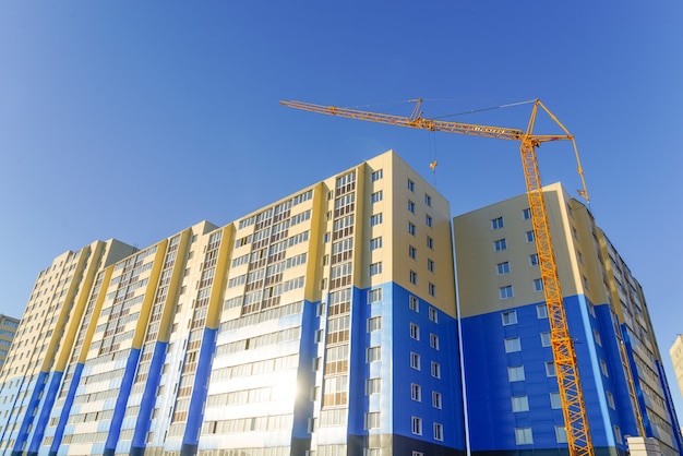 New highrise houses and construction cranes