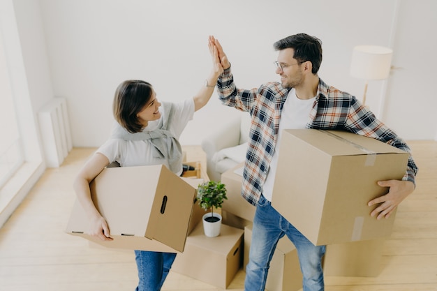 New home. Happy woman and man celebrate moving to new apartment