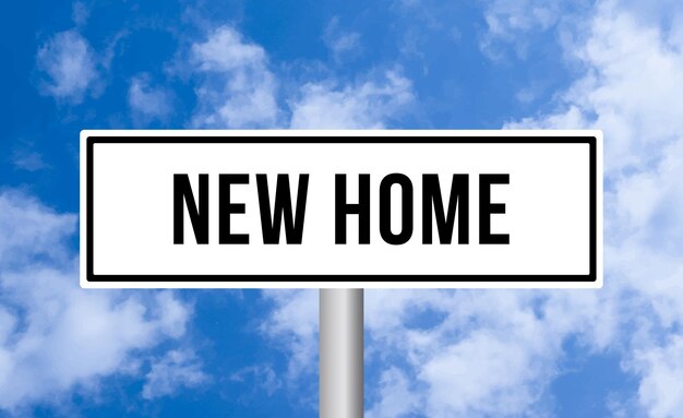 New home road sign on cloudy sky background