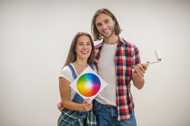 New house. Young couple discussng the wall color in a new house and smiling