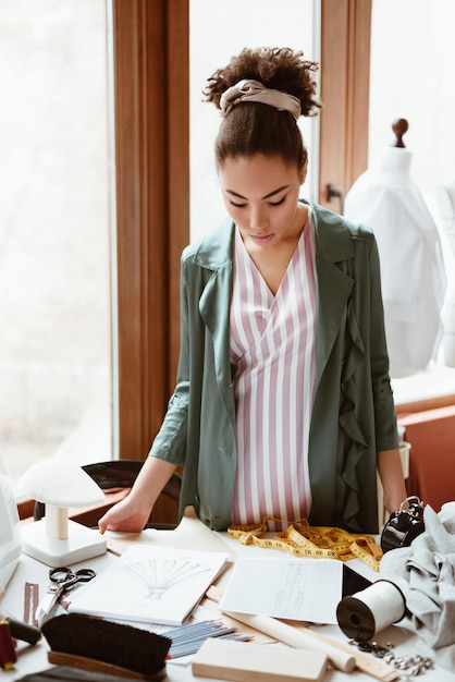 写真 新しい服を開発しようとしているファッションの若い女性の仕立て屋の新しいアイデア