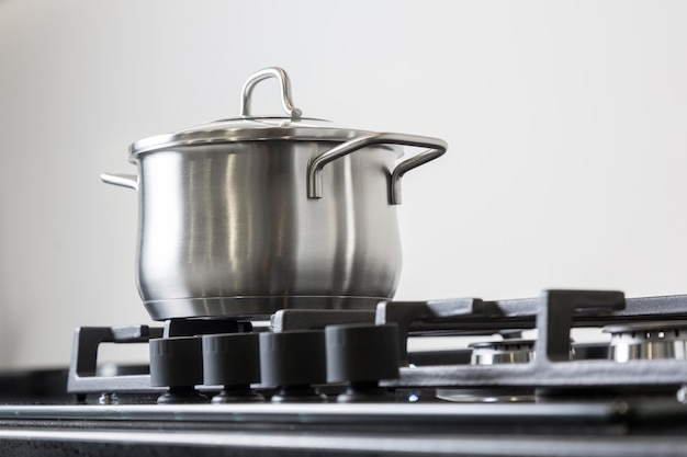 New iron pot on a black gas stove on a kitchen