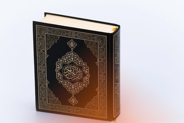 New Islamic concept Holy Al Quran with written Arabic calligraphy meaning of Al Quran Arabic word translation The Holy Al Quran holy book of Muslim on white background with copy space