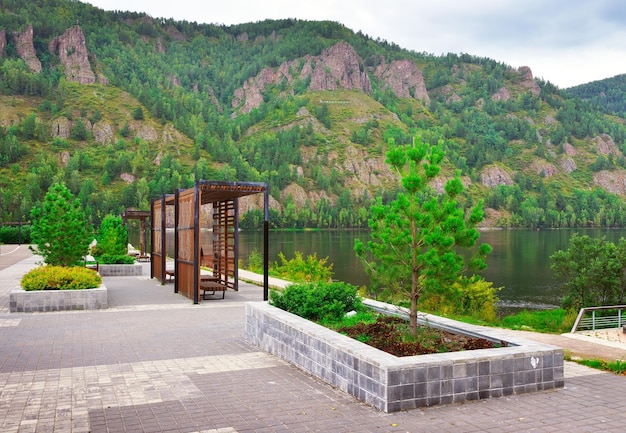 New landscaping of the city embankment on the background of a rocky shore inscription Divnogorsk