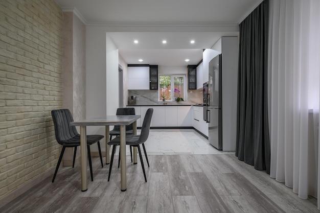 New large modern well designed white kitchen and dining room in studio flat interior