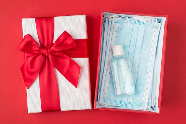 New life style present for birthday concept. Top above overhead close up view photo of package with pile of masks inside isolated over bright color red background