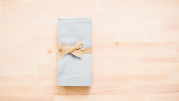 New linen dinner napkin on wood table.