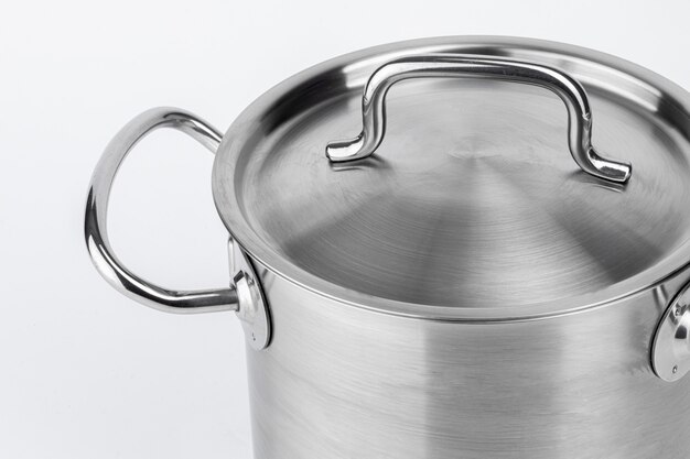 New metal cooking pot on white