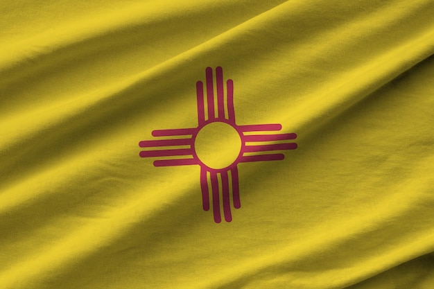 New mexico us state flag with big folds waving close up under the studio light indoors the official