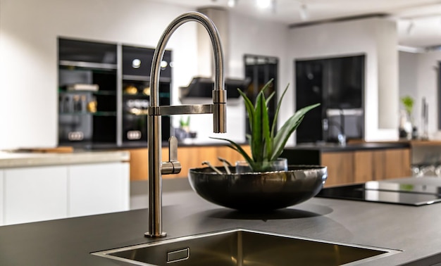 New modern steel faucet and kitchen room sink close up