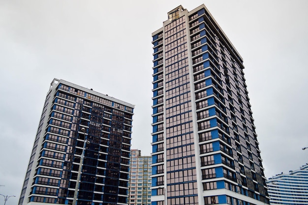 New modern tall blue glass multistorey comfortable urban monolithic frame houses buildings