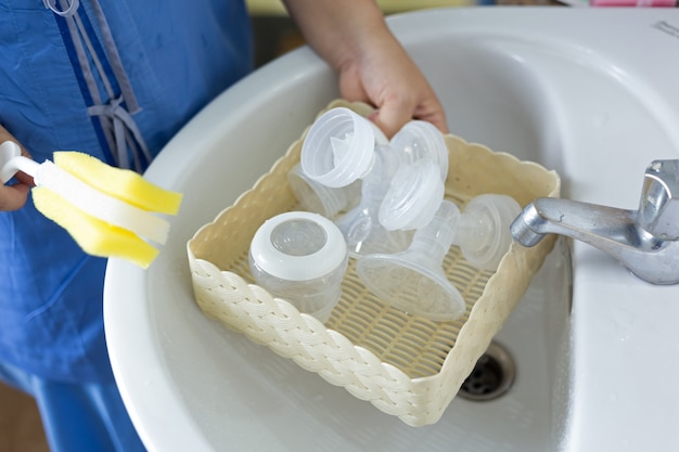 New mother washing the  automatic breast pump. 