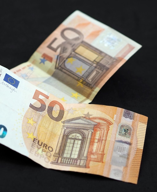 New and old 50 euro banknotes stand on black background