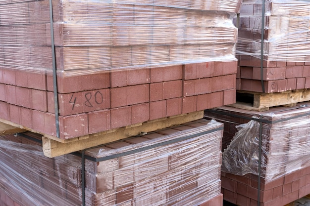 New paving slabs neatly stacked on pallets repair of sidewalks\
and replacement of paving slabs reconstruction of urban\
infrastructure