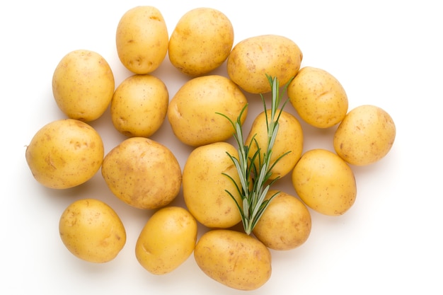 New potato and rosemary isolated on white table