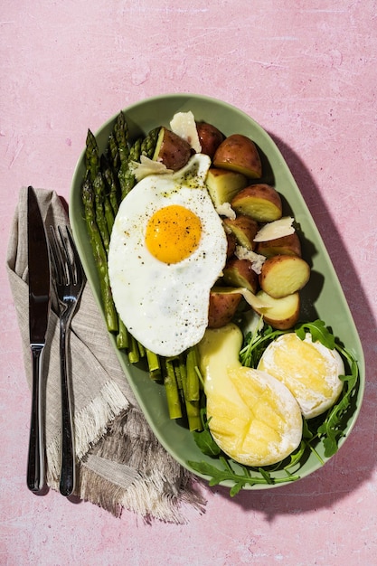 New potatoes with boiled asparagus with eggs and cheese idea for breakfast or lunch