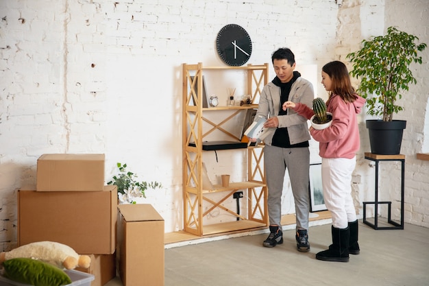 New property owners young couple moving to new home apartment look happy