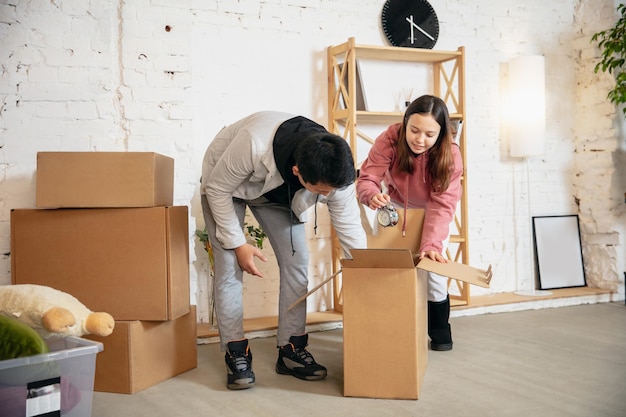 New property owners young couple moving to new home apartment look happy