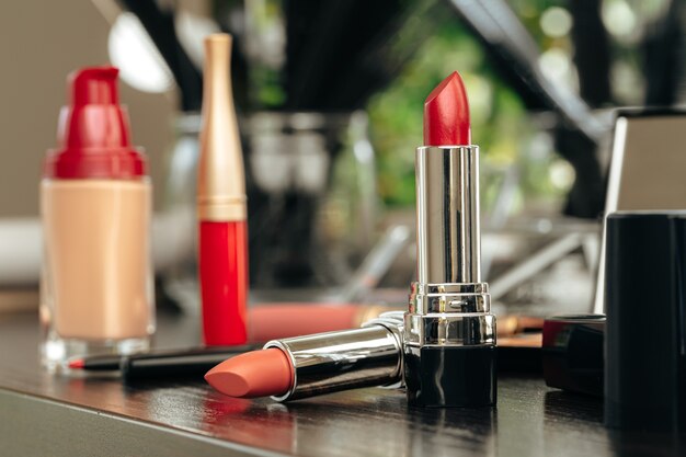 New red lipstick on vanity table close up