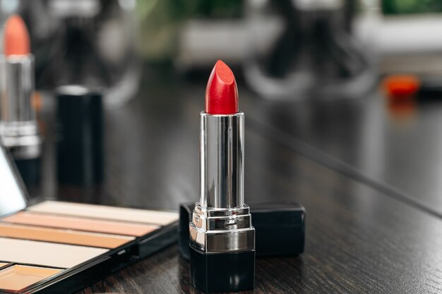 New red lipstick on vanity table close up