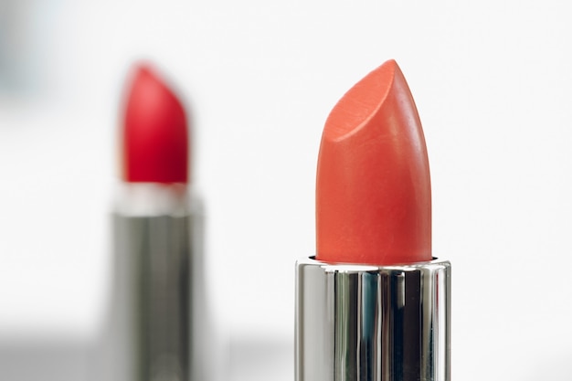 New red lipstick on vanity table close up