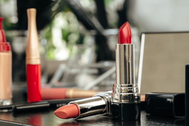 New red lipstick on vanity table close up