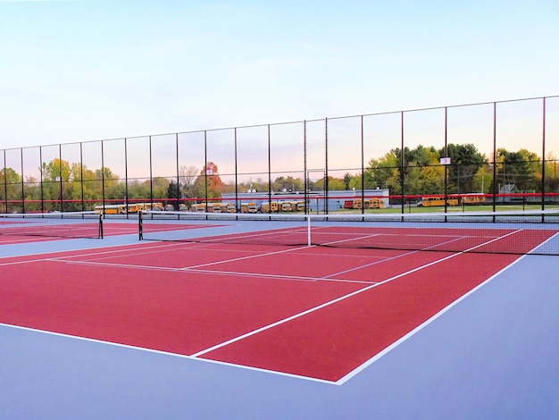 New red tennis court with white lines combined with gray pickleball lines