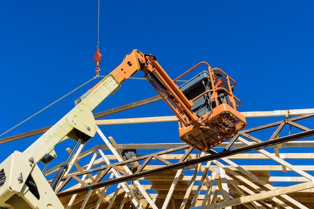 New residential construction home framing the crane holds is wood roofing