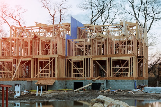 New residential wooden construction home framing against a blue sky