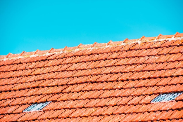 屋根の窓と屋根の保護と青い空を備えた新しい屋根工事。
