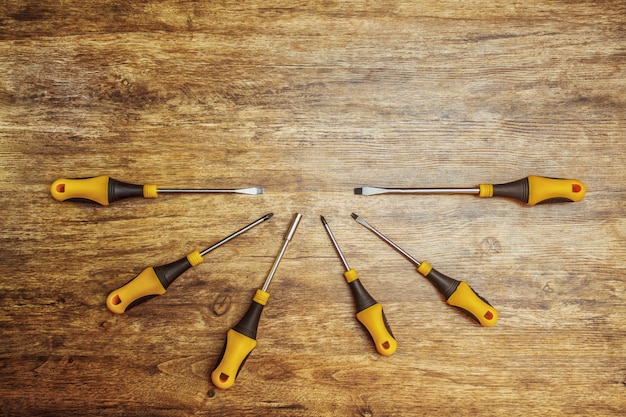 A new set of screwdrivers on wooden background. 