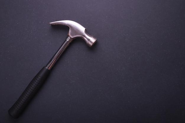 New silver hammer on black granite board background