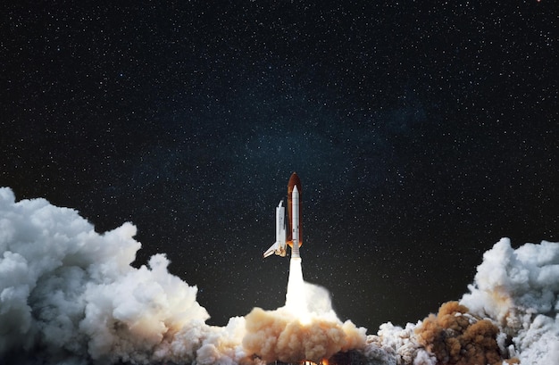 New space shuttle rocket with smoke and blastoff successfully takes off into the starry sky Spaceship liftoff into deep dark space concept Travel to cosmos