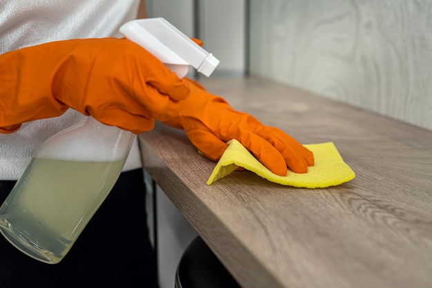 In the new spacious kitchen with new furniture the cleaning lady carries out professional cleaning Cleaning concept