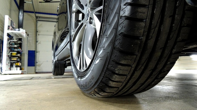 New Tires Mounted On Car At Garage
