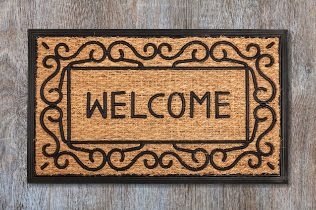 New welcome doormat on wooden floor