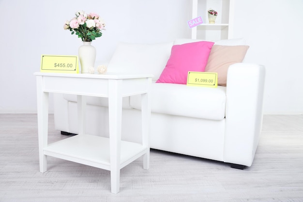 New white furniture with prices on light background