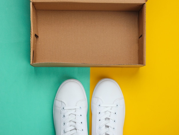 New white sneakers and  box on two-ton paper