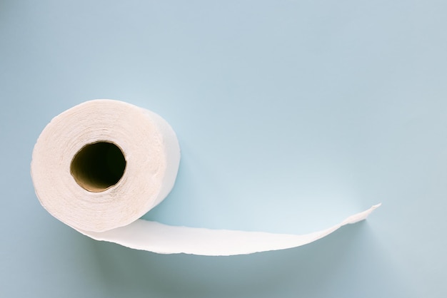 New white toilet paper roll on blue background