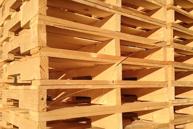 New wooden pallets is stack in the warehouse of cargo delivery enterprise.