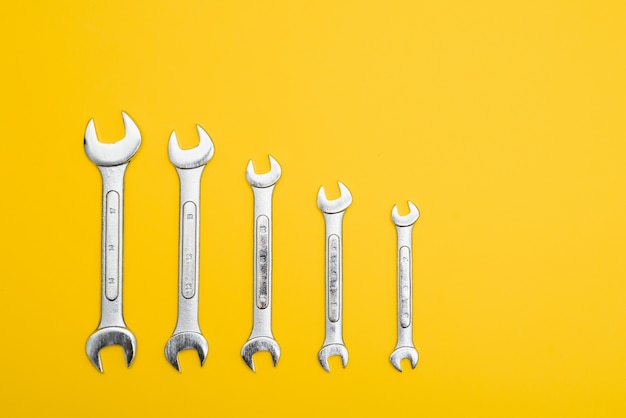 New wrenches on a yellow background