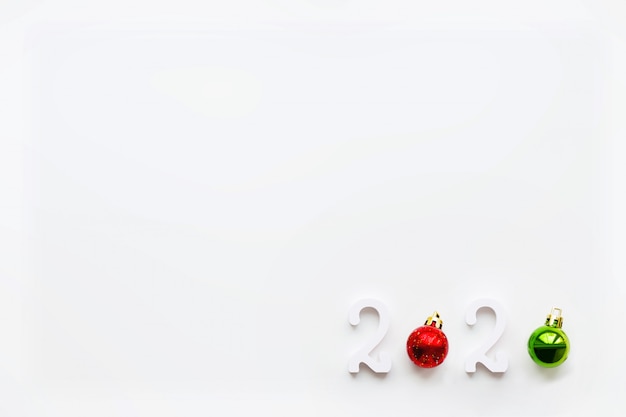 New Year 2020 background with bright red ball. White copy space.