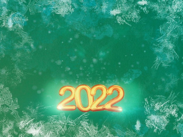 Photo new year 2022 in golden letters with green background ice and particles